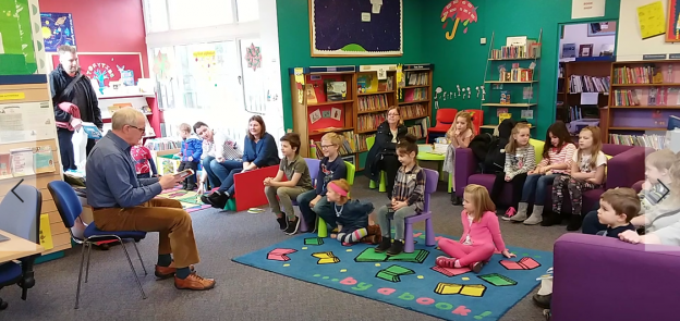 Children sitting around a storyteller.